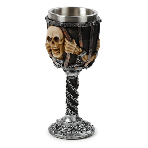 Decorative goblet featuring a bone-coloured skull and skeletal hands appearing to emerge from dark, distressed bars on the cup, entwined with silver chains. The stem is wrapped in spiralling silver chains, and the round base is decorated with small skulls and chains.
