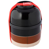Angled view of a round, stacked bento lunch box. It features a glossy black top tier, a matt black second tier, a reddish-brown third tier, and a light beige base tier. A bright red strap forms a handle and holds the four compartments together.