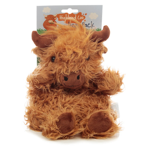 Front view of a fluffy, ginger-brown Highland Coo cow microwavable wheat heat pack, sitting upright, with its product packaging visible behind.