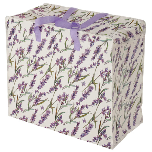 Angled view of a white rectangular laundry and storage bag, featuring a purple lavender floral print, lilac fabric handles, and a top zip closure.