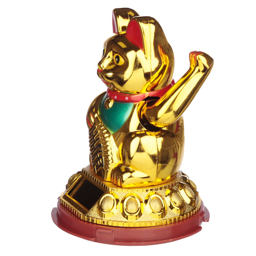 Angled view of a golden waving Maneki Neko lucky cat figurine, featuring black eyes, a red collar, green bib, and a solar panel on its patterned golden and reddish-brown base.