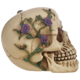 Right side view of a bone-coloured gothic skull figurine, decorated with purple roses and green vines.