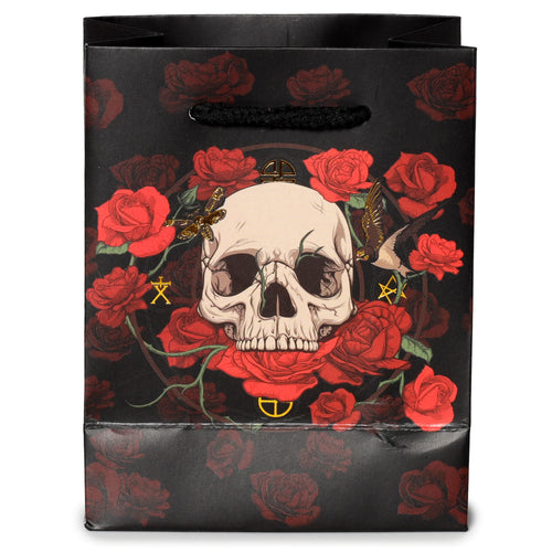 Front view of a small black gift bag featuring a skull and red roses design, with black handles.