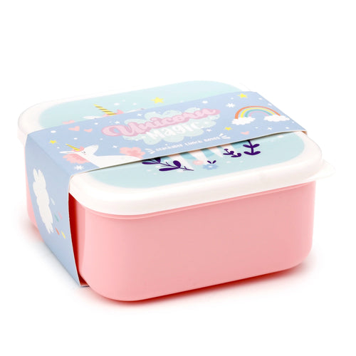 Angled view of a pink lunch box with a white lid, featuring a light blue decorative band with a colourful unicorn, rainbow, and 'Unicorn Magic' design, part of a stackable lunch box set.