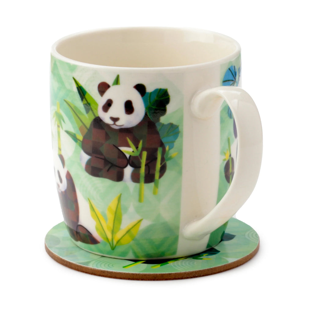 Angled view of a porcelain mug and coaster set. The white mug features a green-themed illustration of a panda amongst bamboo and foliage. It has a white handle and is placed on a coordinating green coaster with a natural brown edge.