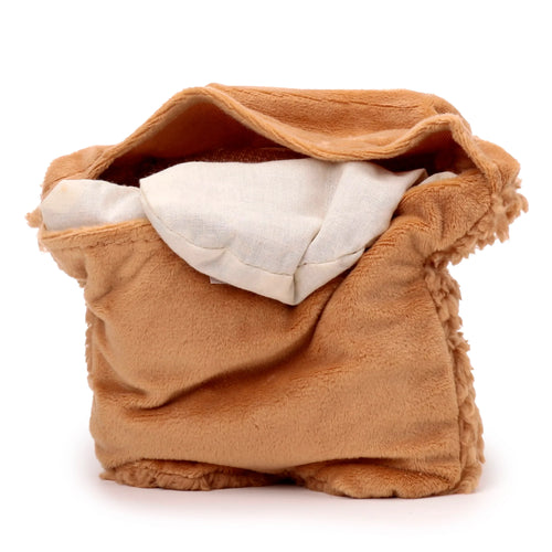 Angled view of a brown plush heat pack, showing the soft texture and cream-coloured inner fabric bag, on a white background.