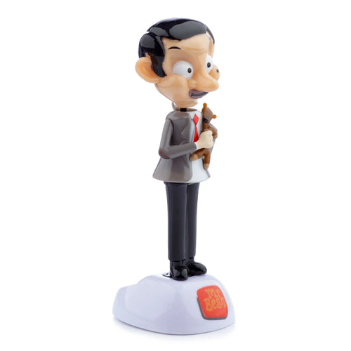 Side view of a Mr Bean and Teddy Solar Powered Pal figurine. Mr Bean wears a grey suit, holds a brown teddy bear, and stands on a white base displaying the Mr Bean logo.