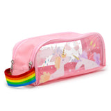 Angled front view of a pink pencil case with a clear window showcasing a unicorn, cloud, and rainbow design, featuring a pink zip and rainbow-striped strap.