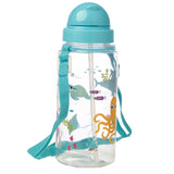 Angled view of a transparent children's water bottle, featuring a teal pop-up straw cap and an attached teal carry strap. The bottle is decorated with a vibrant sealife pattern, depicting an orange octopus, a shark, manta ray, and various colourful fish amidst coral.