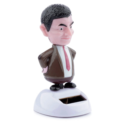 Front view of a Mr Bean solar pal figurine, dressed in a brown suit, white shirt, and red tie, with hands on hips, standing on a white base featuring a solar panel.