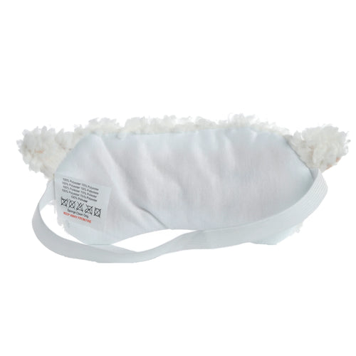 Plush sheep eye mask displayed on a soft, light-coloured linen surface, ready for sleep.