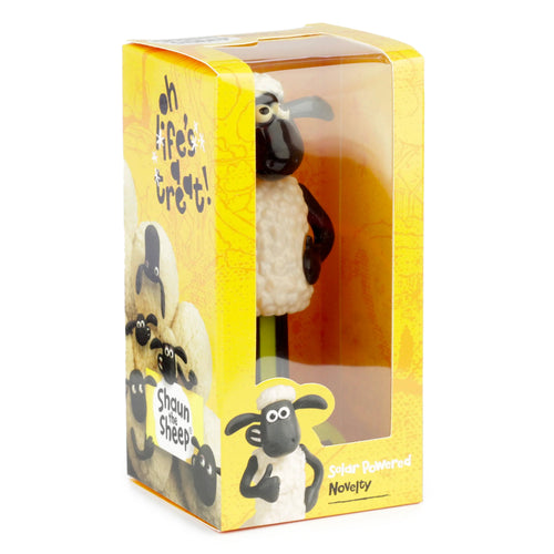 Angled view of a Shaun the Sheep solar powered novelty pal in its yellow display box with a clear window.