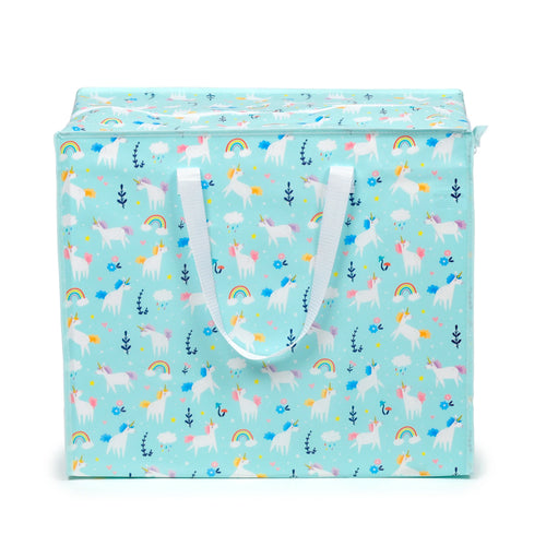 Front view of a light blue laundry and storage bag, decorated with a colourful pattern of white unicorns, rainbows, clouds, stars, hearts, and flowers. The bag has white carrying handles and a zip closure.