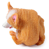 Rear-angled view of an orange Corgi stretch toy, featuring textured fur, white markings, and pink inner ears.
