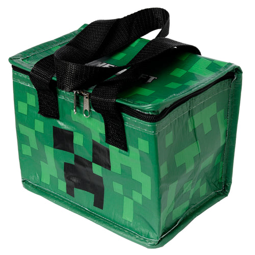 Angled front view of a green cool bag, featuring a black pixelated Minecraft Creeper face design. It has black woven carry handles and a top zip closure.