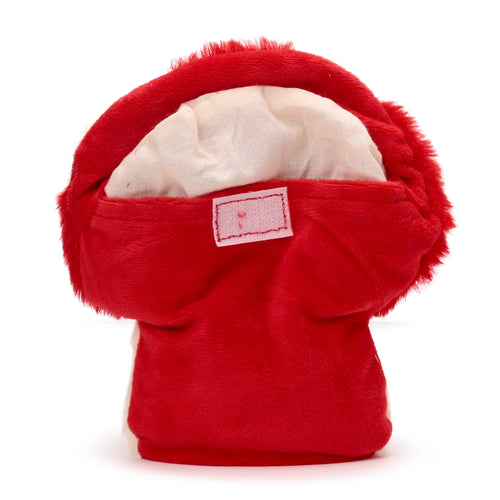 Angled view of a red plush mushroom heat pack, revealing the opening flap with a small stitched label and light inner fabric.