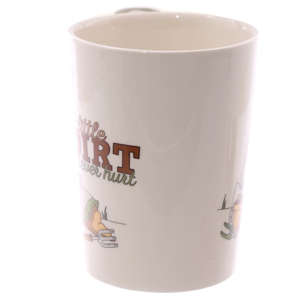 Angled view of an off-white ceramic mug, displaying a partial garden-themed graphic with 'a little dirt never hurt' text and illustrations of gardening tools.