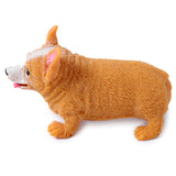 Left side profile of an orange-tan and white Corgi stretch toy, featuring a textured fur-like surface, black eyes and nose, and pink inner ears with a pink tongue playfully sticking out.