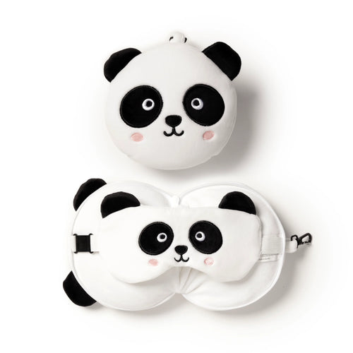 Overhead view of a white and black plush panda travel pillow and matching eye mask set. The main round panda head pillow is at the top. Below it, the travel pillow is unfolded, showing the panda eye mask stored inside, all with embroidered features and pink cheek details.
