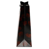 Side view of a black gift bag with red rose patterns and black rope handles.