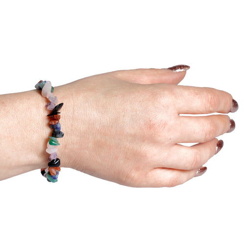 Multi-coloured tumbled gemstone bracelet worn on a wrist, showcasing assorted natural stone colours.