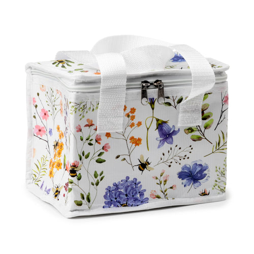 Angled view of a white cool bag featuring a Nectar Meadows floral and bee pattern, with white webbing handles and a twin zip closure on the top.
