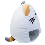 Angled view of a round, white Lola the Cat plush toy with an orange ear, embroidered black whiskers, a pink cheek, a grey side patch, and a grey and orange tail.