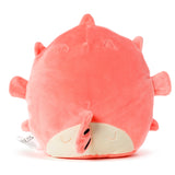 Angled view of a coral pink pufferfish plush toy, featuring a cream-coloured belly with embroidered sleepy eyes, a striped tail, and small fins.