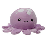 Front view of a lavender plush octopus cushion with embroidered black eyes, smiling mouth, and white spots on its head, showing its soft arms.