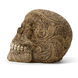 Side profile view of a Damask Skull Ornament, a cream-coloured figurine intricately adorned with raised damask patterns featuring swirls, circles, and paisley motifs, revealing its teeth.