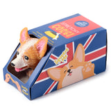 Angled view of a brown and white Corgi stretchy toy, its head and pink tongue visible through an opening in blue packaging featuring a red and white Union Jack flag design.