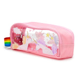 Angled view of a pink clear window pencil case, featuring multiple white unicorn illustrations with colourful manes and horns, pink hearts, white clouds, and multi-coloured raindrops. The case has a pink zip closure and a striped rainbow fabric pull tab.