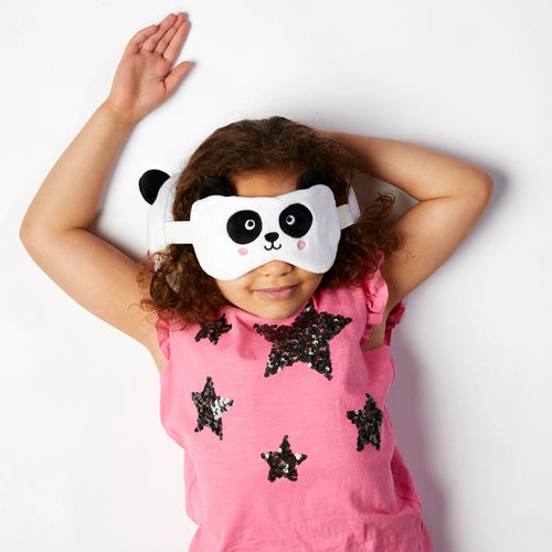 Lifestyle shot from above of a child wearing a white plush panda eye mask with black eyes, nose, and ears.