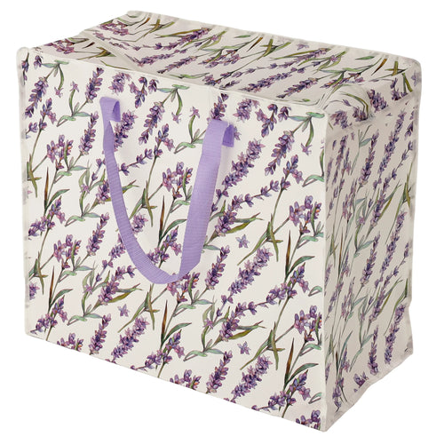 Angled view of a white laundry and storage bag, featuring a purple lavender fields pattern and lilac fabric handles.