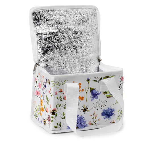Angled view of an open cool bag with a white exterior featuring a colourful floral and bee pattern, showing the silver thermal lining inside and white carrying straps.